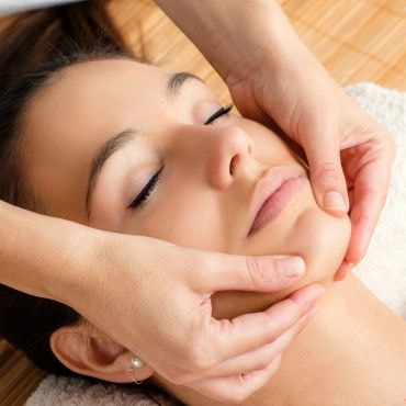 Woman receiving facial massage